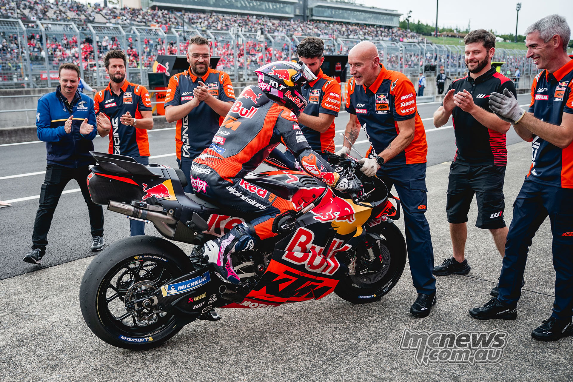 Enea Bastianini is congratulated by KTM team members after finishing fourth at Motegi