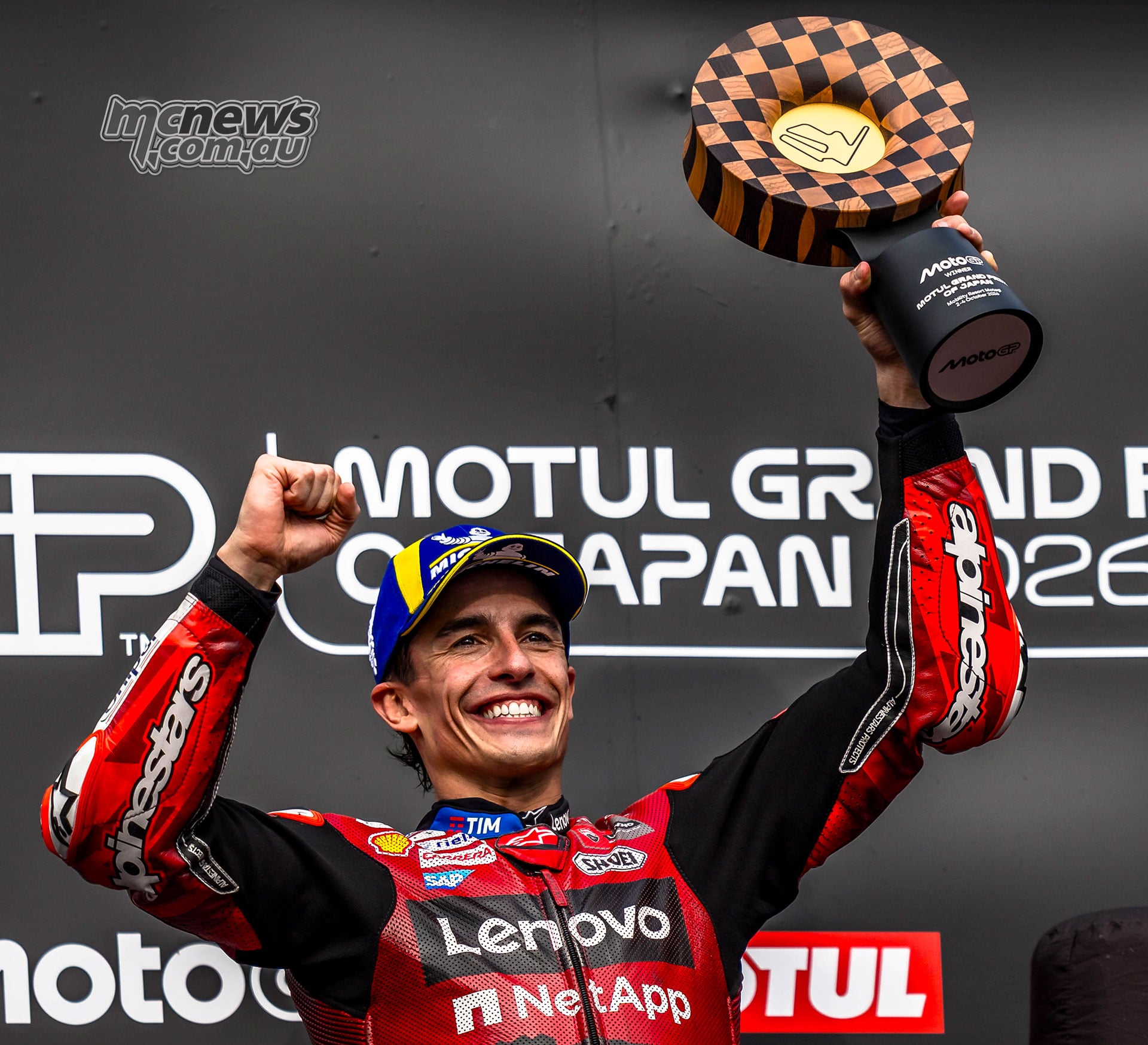 Marc Marquez celebrates victory with the Japanese MotoGP winner trophy at Motegi