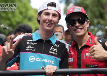 Máximo Quiles, left, makes a peace sign beside Marc Márquez, who gives a thumbs-up, during the 2026 Mandalika rider parade.