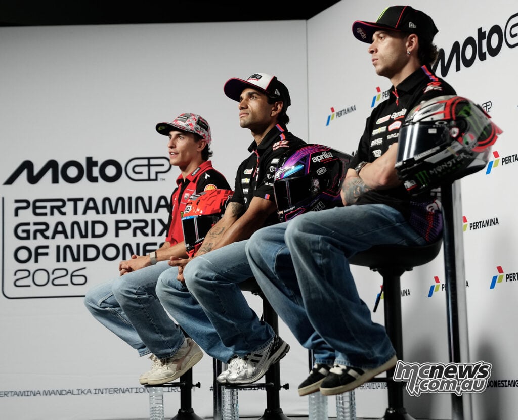 Marc Marquez, Jorge Martin and Marco Bezzecchi sit with their helmets at the 2026 Indonesian Grand Prix press conference.