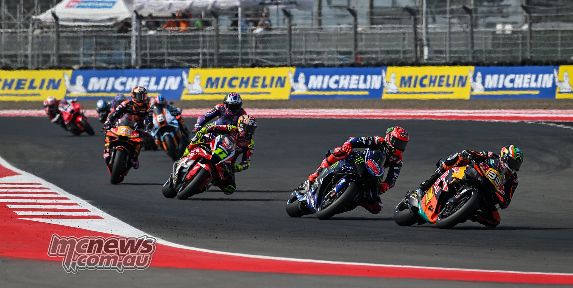Brad Binder leads Fabio Quartararo and Diogo Moreira through a right-hand bend.