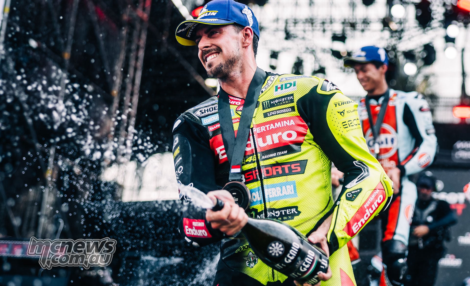 Fabio Di Giannantonio sprays a bottle during the Sprint podium celebrations.