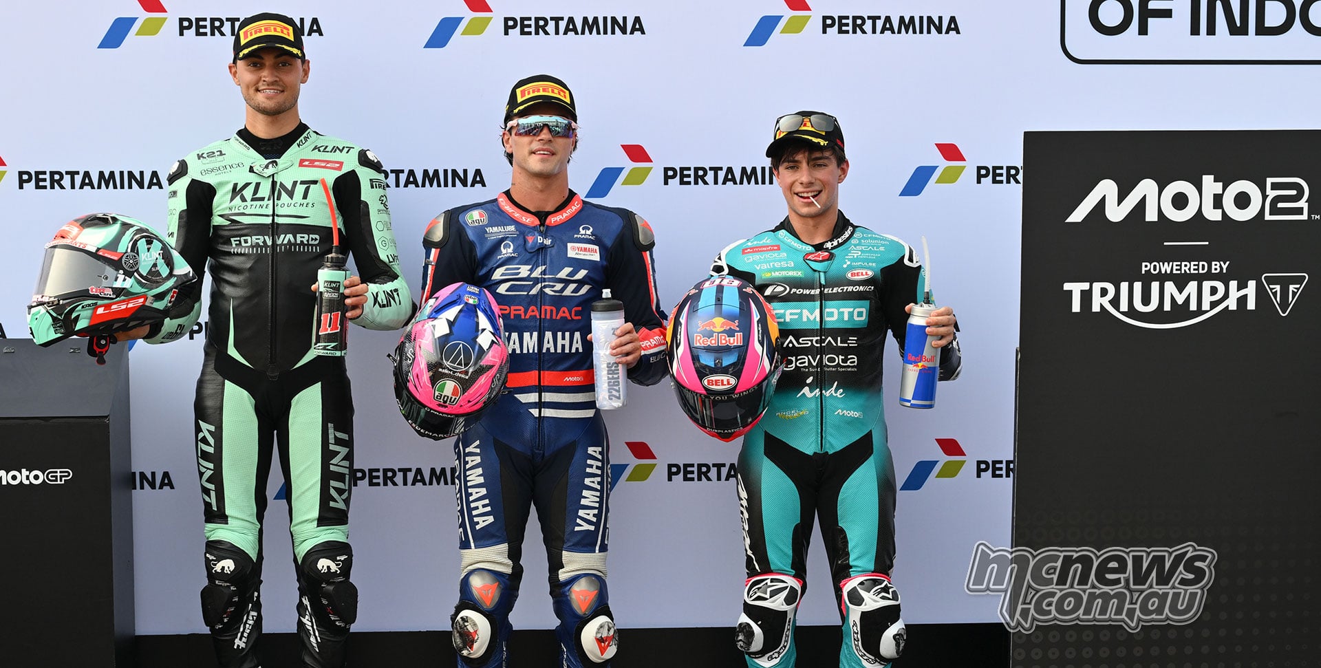 Alex Escrig, Izan Guevara and David Alonso pose with their helmets after Moto2 qualifying.