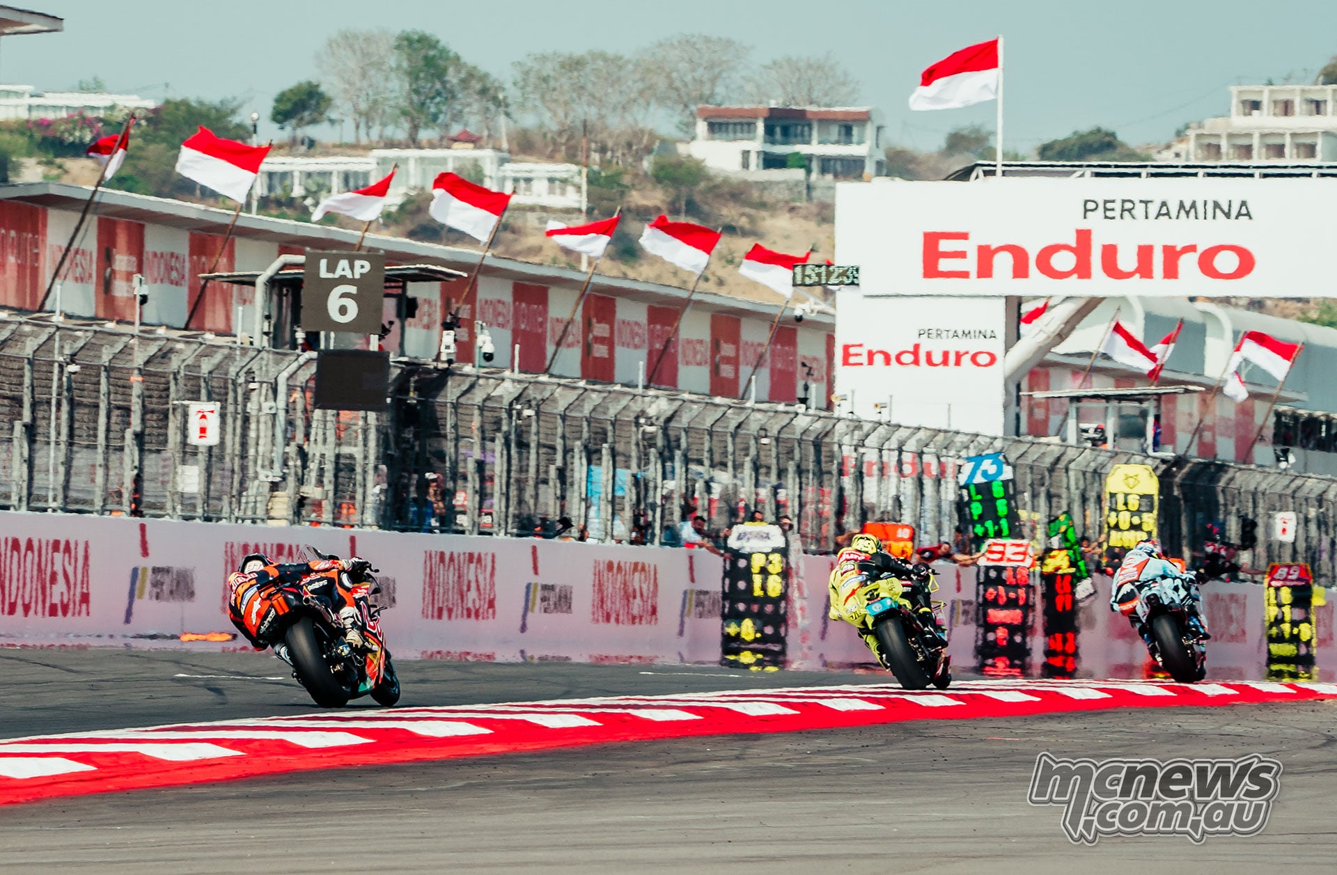 Ai Ogura, Fabio Di Giannantonio and Pedro Acosta accelerate along the Mandalika pit straight.