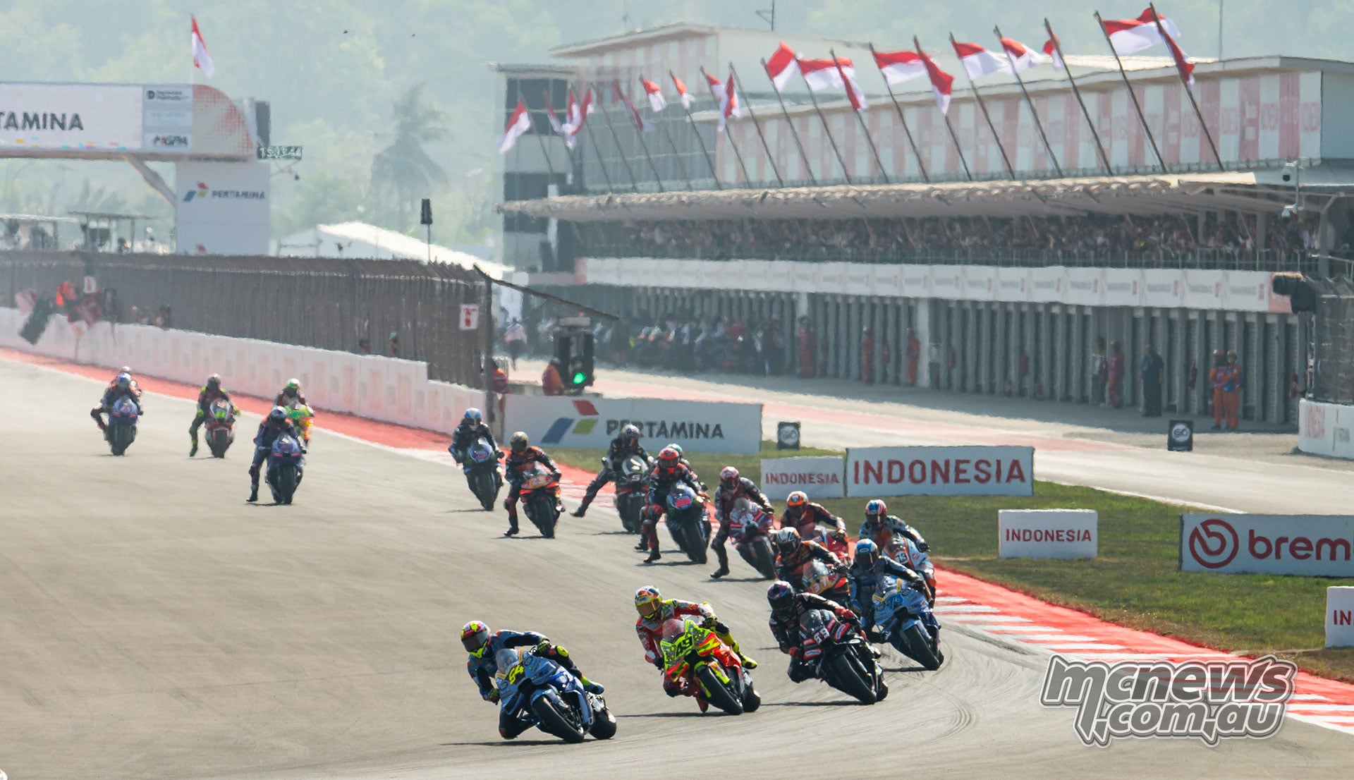 Fermin Aldeguer, Fabio Di Giannantonio and Jorge Martin heading a group of riders beside the Mandalika pit lane
