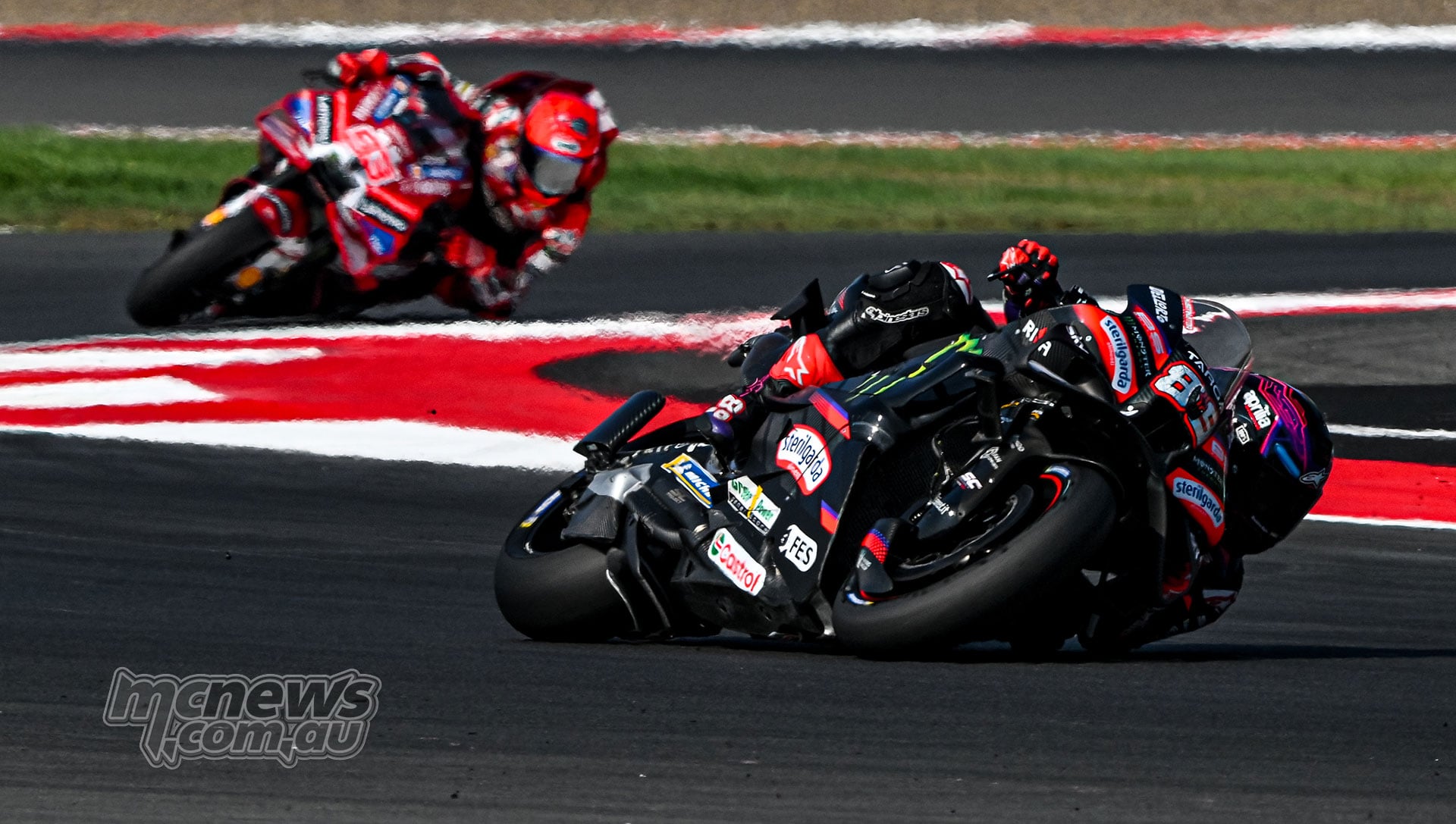 Jorge Martin leaning his Aprilia through a corner with Marc Marquez following on the Ducati