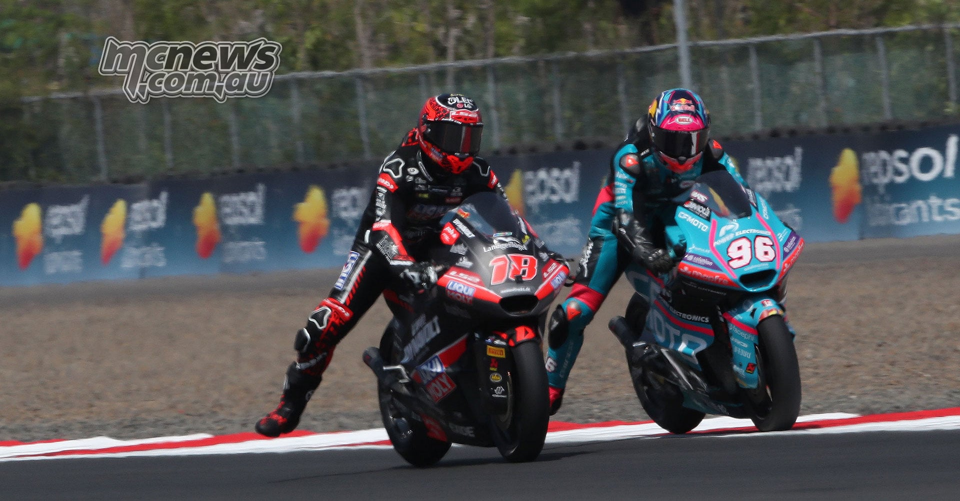Manuel Gonzalez on bike 18 leads Daniel Holgado on bike 96 under braking at Mandalika.