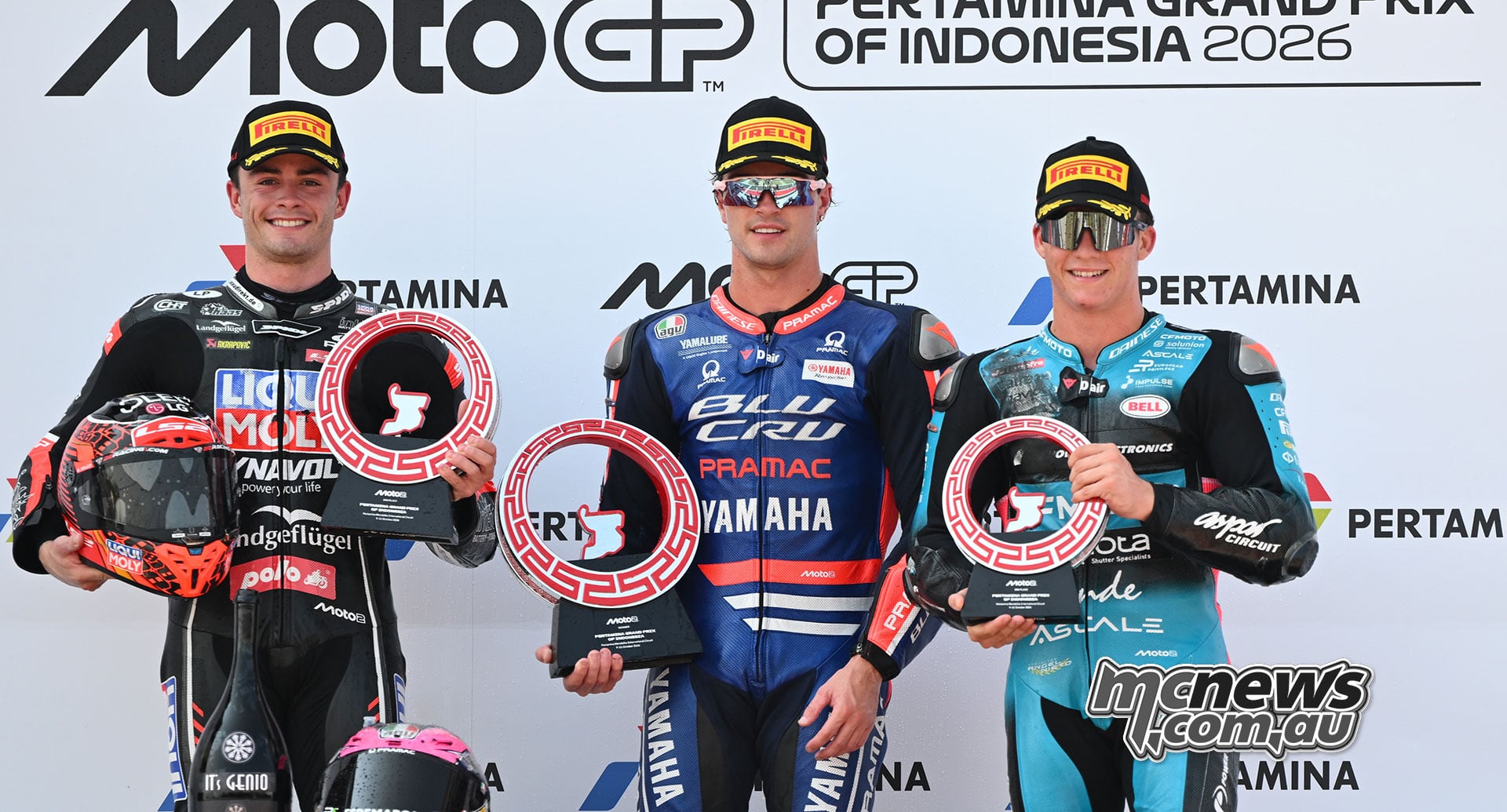 Manuel Gonzalez, Izan Guevara and Daniel Holgado pose with their trophies on the Mandalika Moto2 podium.