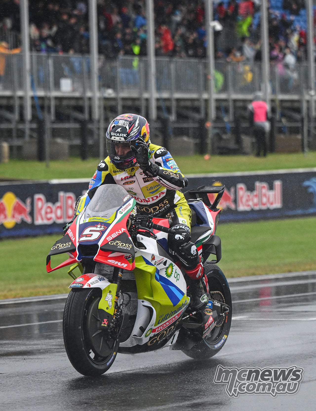 Johann Zarco rides his number five Honda on the wet Phillip Island main straight in front of the grandstand.