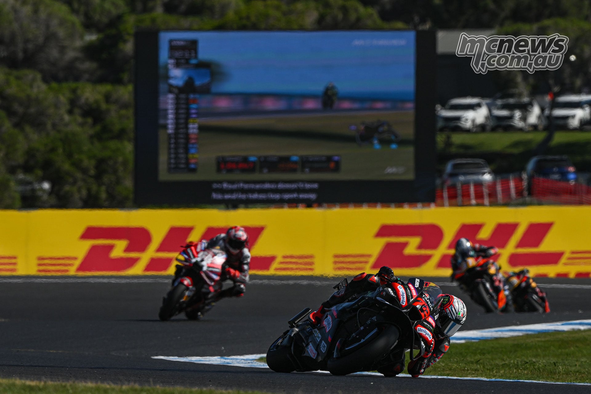 Marco Bezzecchi leads Francesco Bagnaia through a corner at Phillip Island, with another rider further behind.
