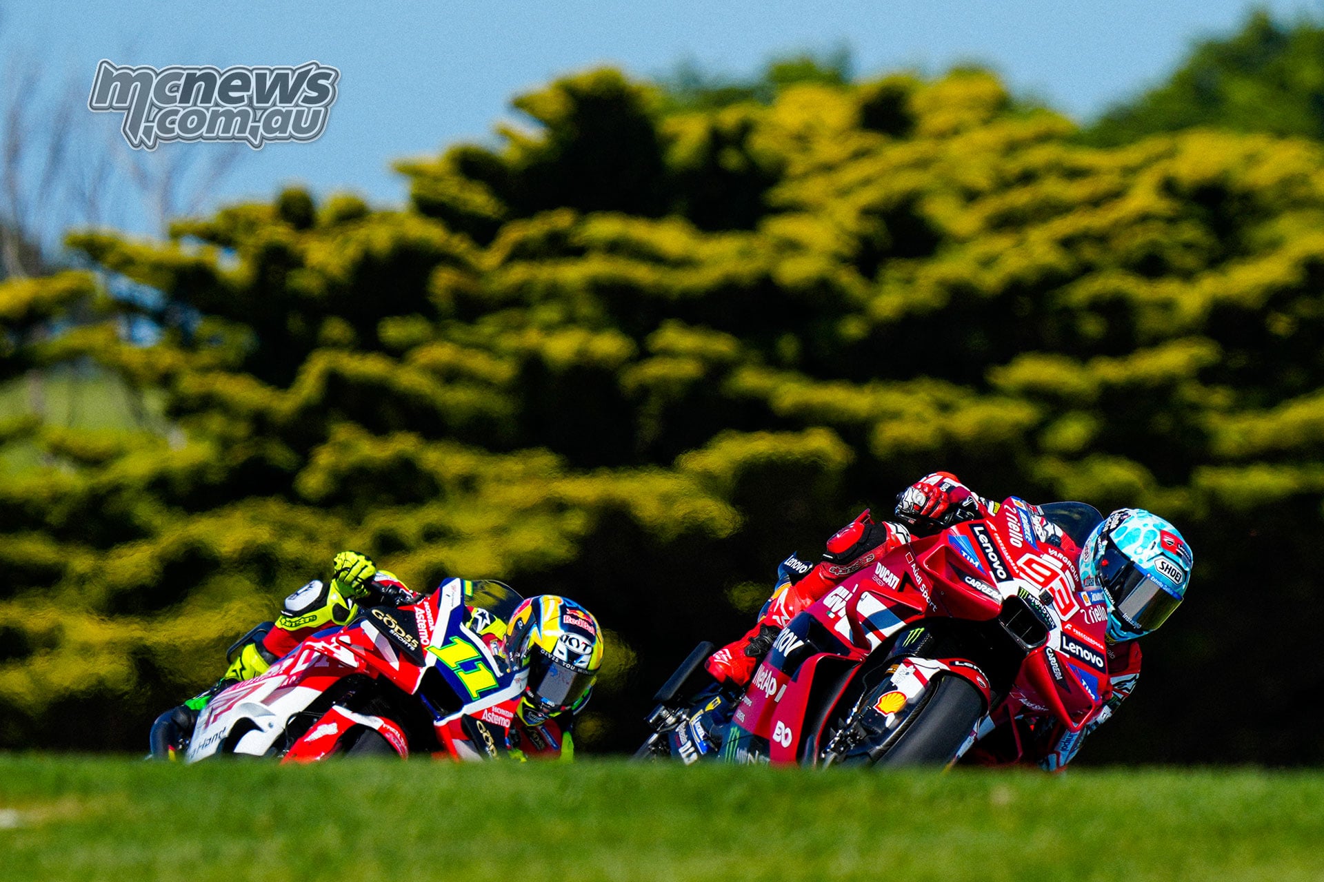 Marc Marquez on the red number 93 Ducati leads Diogo Moreira on the number 11 LCR Honda through a corner.