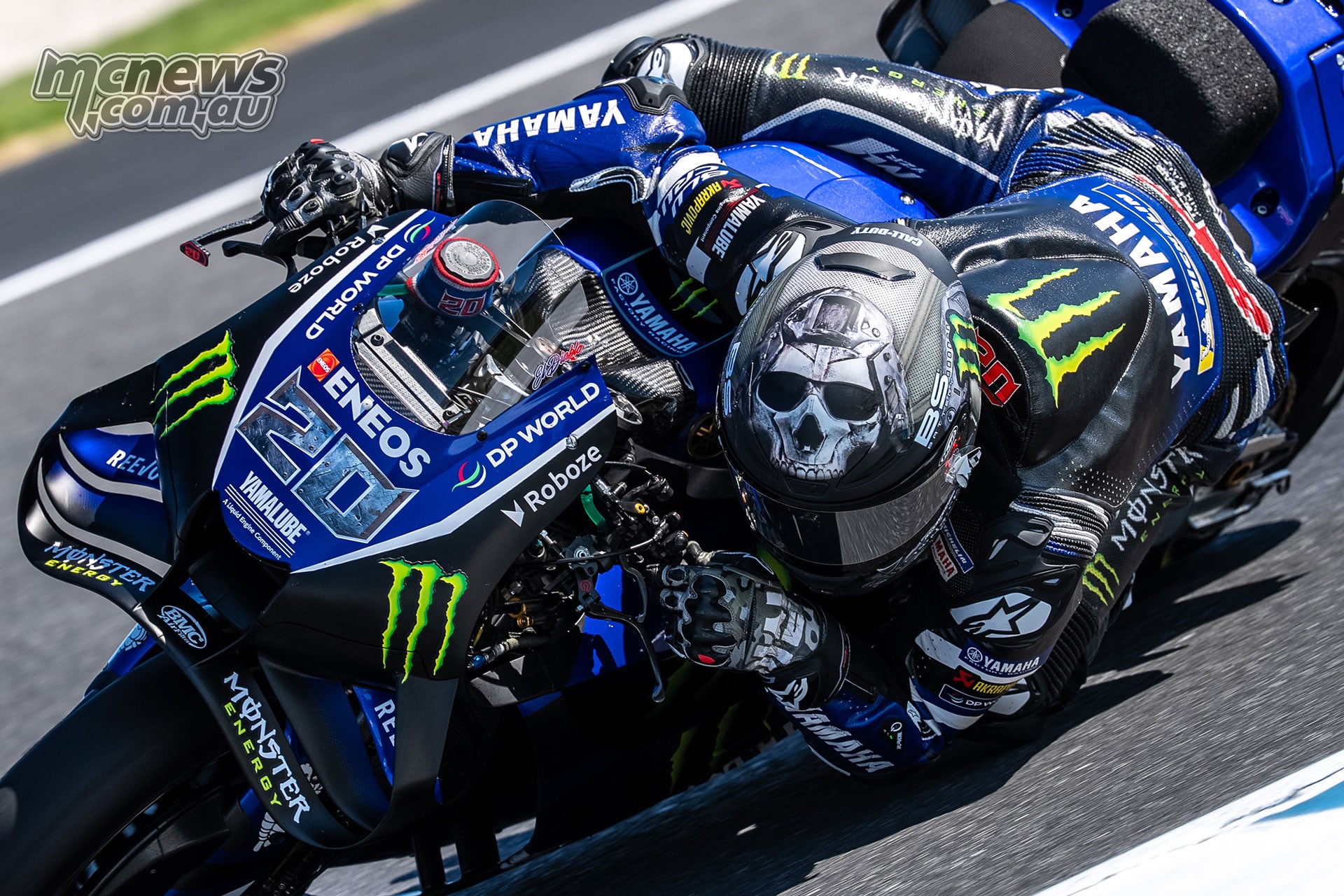 Close view of Fabio Quartararo on his number 20 Yamaha, wearing a Call of Duty-themed helmet, gloves and boots.