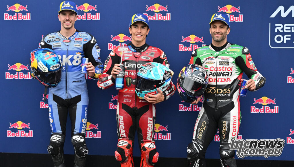 Alex Marquez, Marc Marquez and Johann Zarco pose with their helmets and Michelin caps after qualifying at Phillip Island.