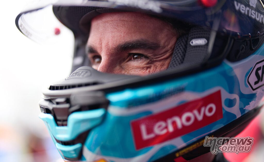 Close-up of Marc Marquez’s eyes inside his turquoise Shoei helmet, with the visor raised.