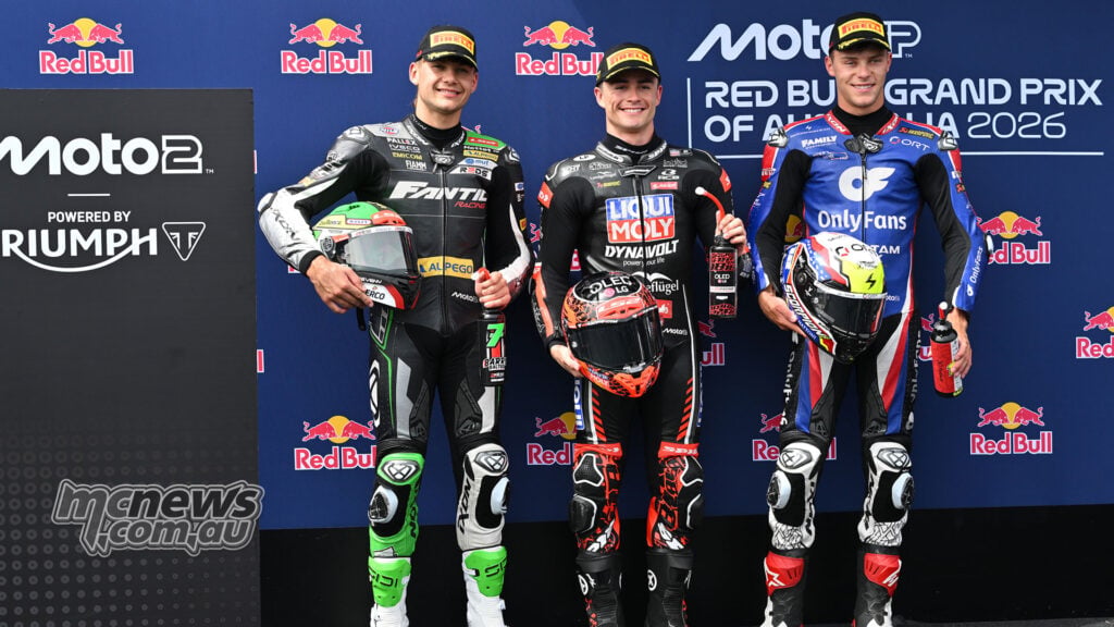 Barry Baltus, Manuel Gonzalez and Filip Salac pose with their helmets after Moto2 qualifying at Phillip Island.