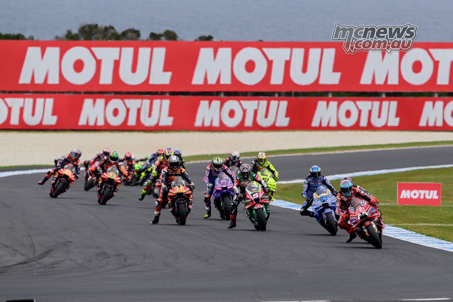 Marc Marquez leads the tightly packed MotoGP field towards Turn Four on the opening lap at Phillip Island.