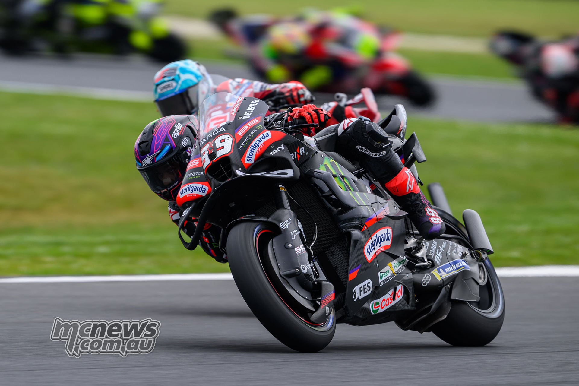 Jorge Martin leans his number 89 Aprilia into a corner with Marc Marquez following closely on his Ducati.