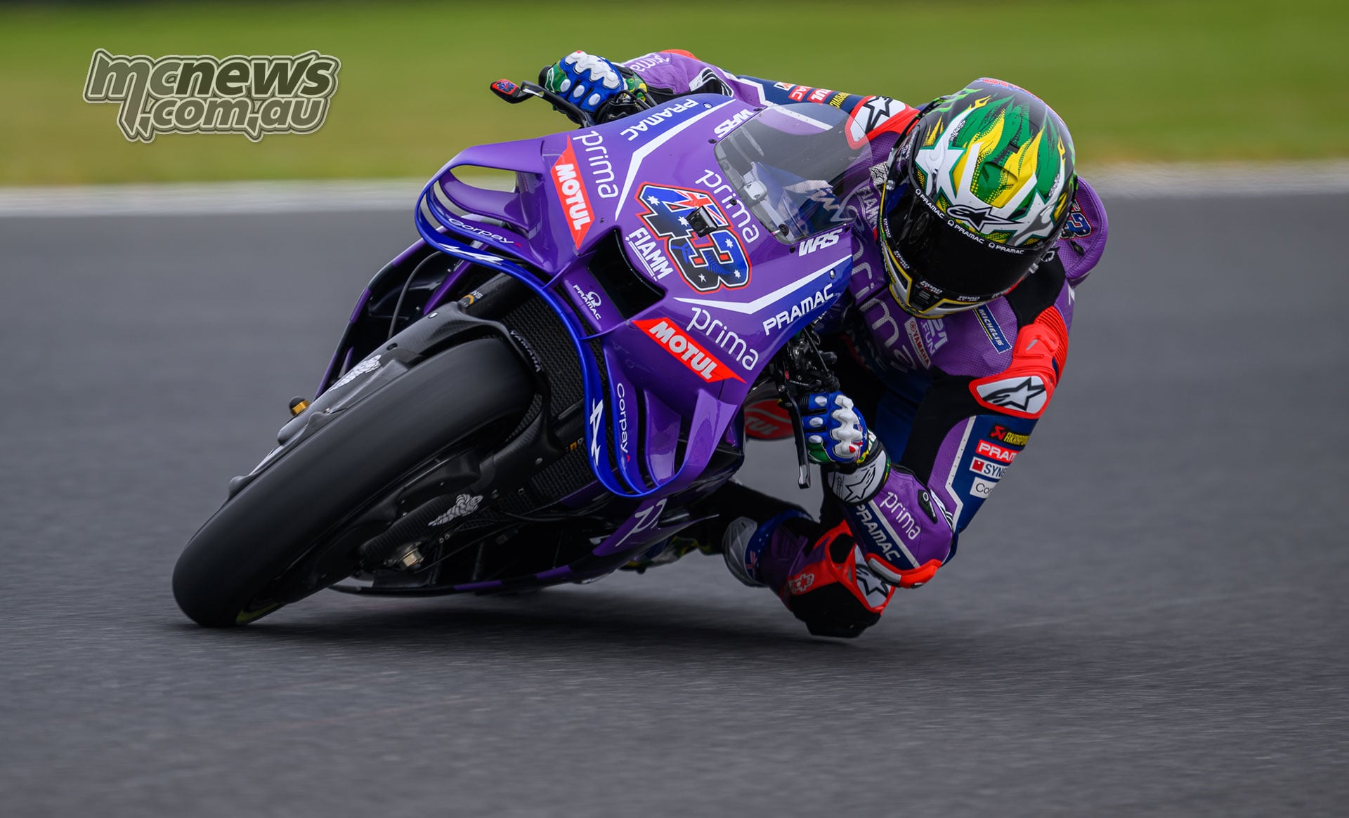 Jack Miller leans his purple number 43 Pramac Yamaha through a corner at Phillip Island, his left knee close to the track.