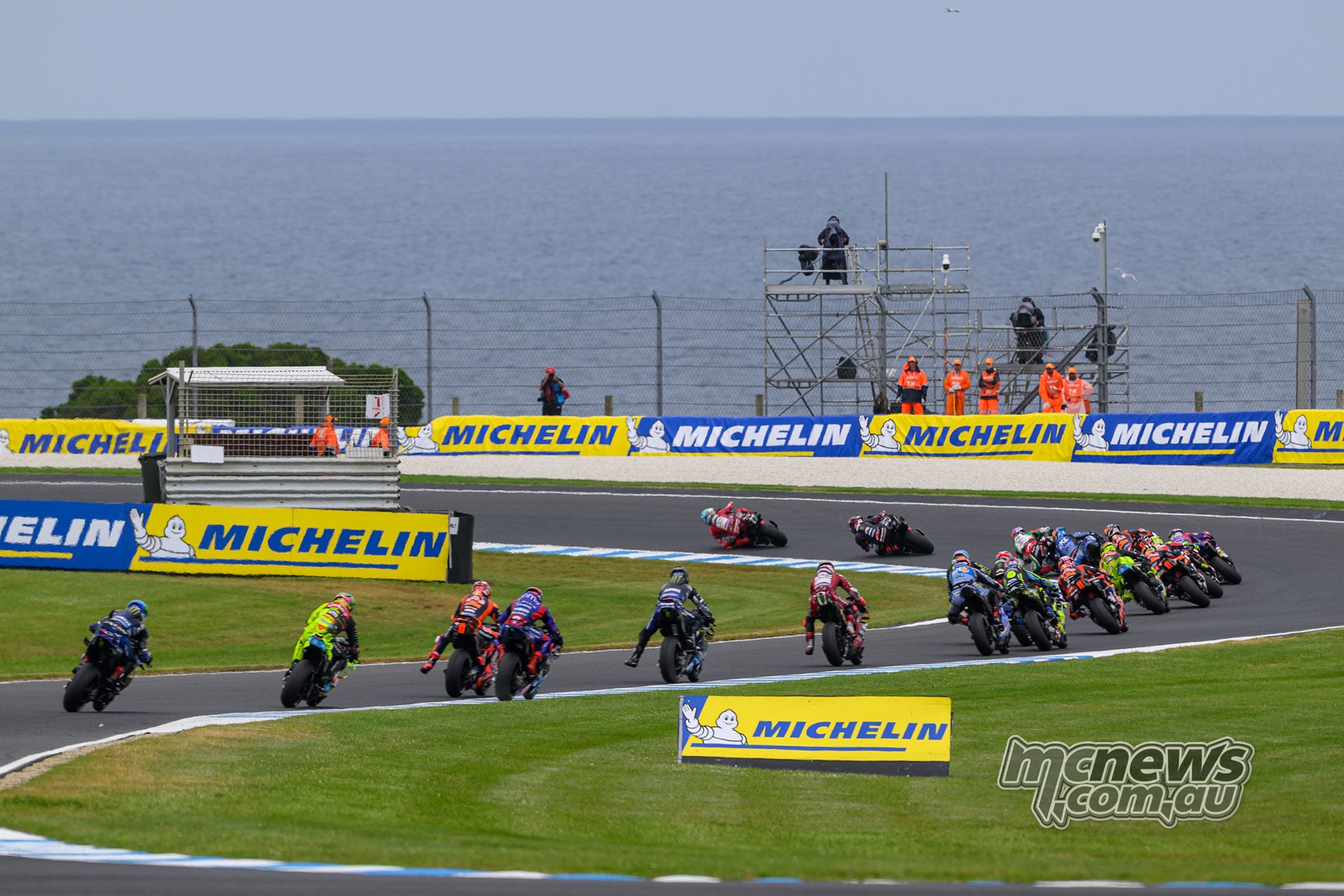 Marc Marquez leads Jorge Martin and the MotoGP field through Siberia, with Bass Strait beyond the circuit.