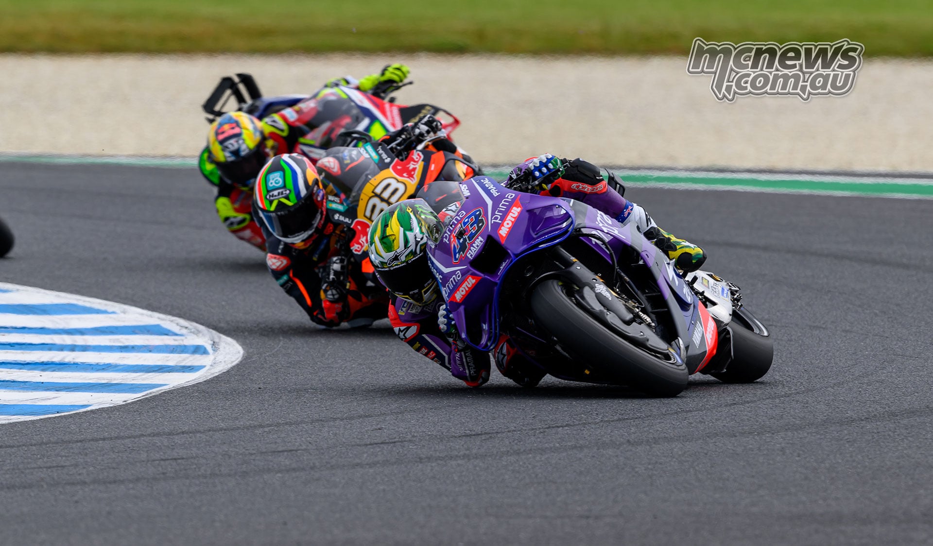 Jack Miller leans his purple Yamaha through Turn Four, closely followed by Brad Binder and Diogo Moreira.