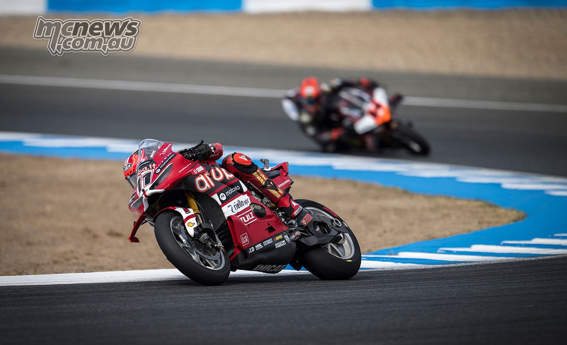 Nicolò Bulega on the red number 11 Aruba.it Racing Ducati leads Sam Lowes through a corner at Jerez