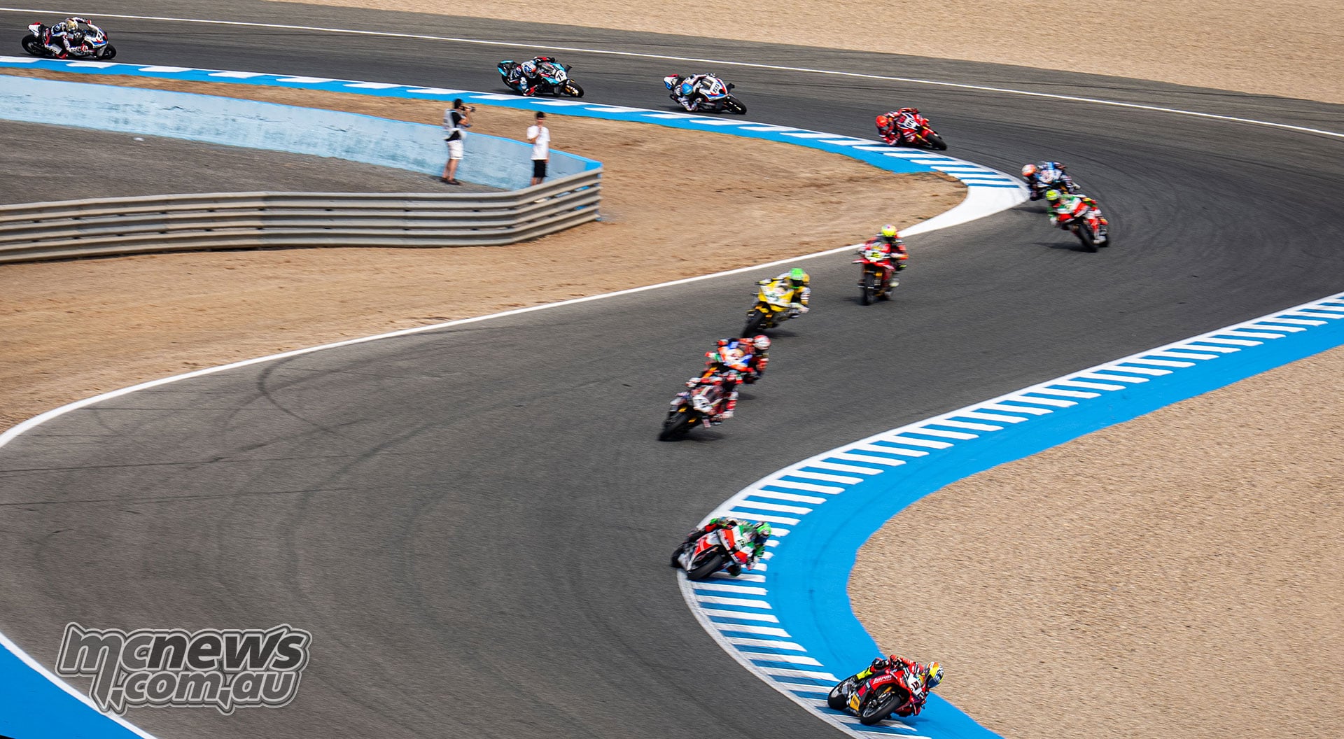 Elevated view of the Jerez WorldSBK field sweeping through a long corner with Yari Montella, Alex Lowes and Tommy Bridewell among the riders
