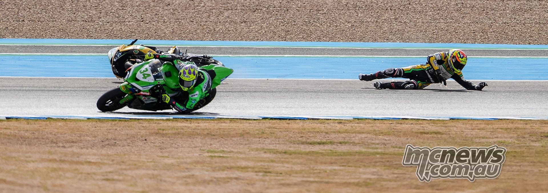 Xavi Artigas continues through the corner on green Kawasaki number 34 while David Salvador slides across the track behind him following his WorldSPB crash at Jerez