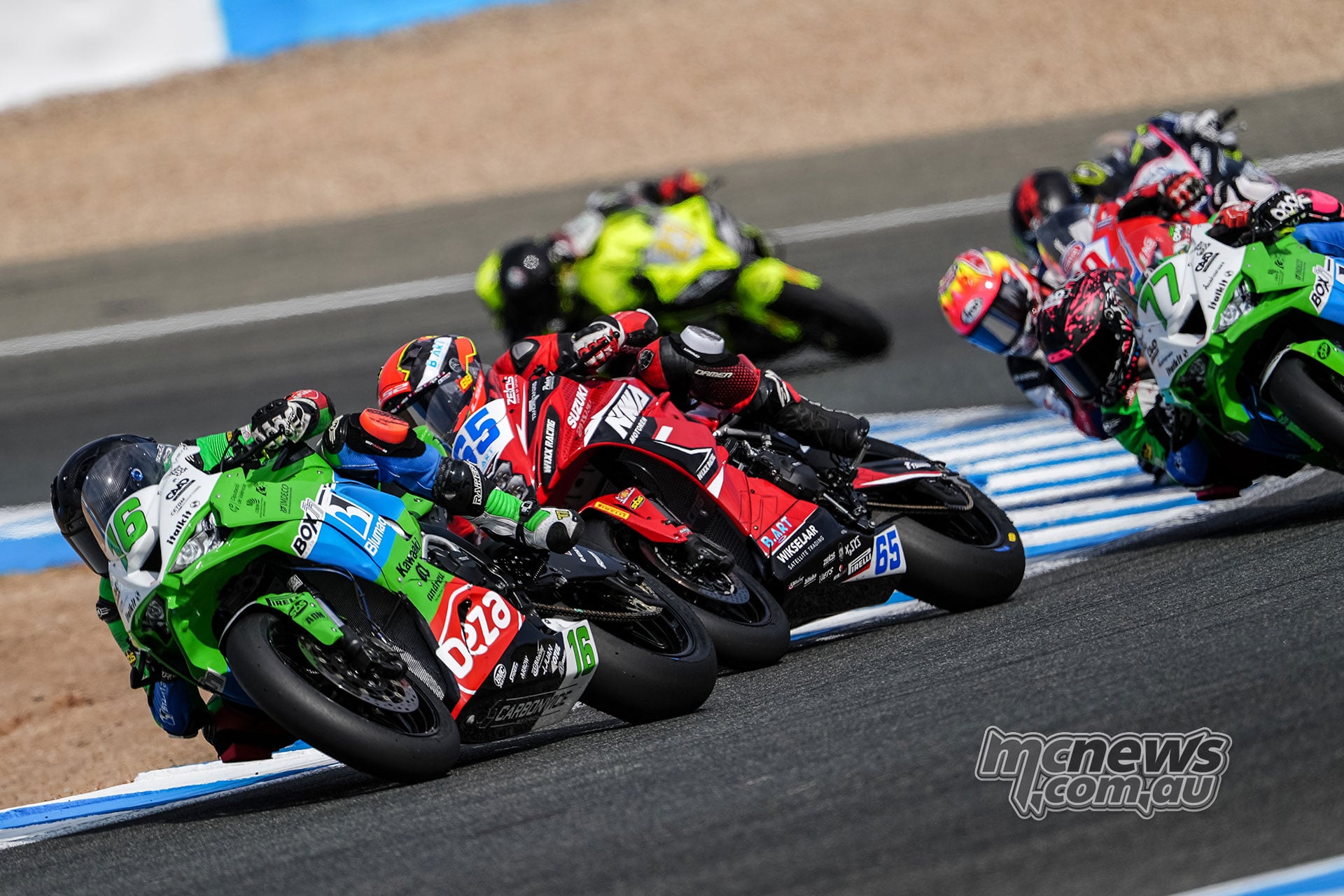 Álvaro Fuertes on Kawasaki number 16, Ferre Fleerackers on Suzuki number 65 and Pepe Osuna on Kawasaki number 77 race closely together at Jerez