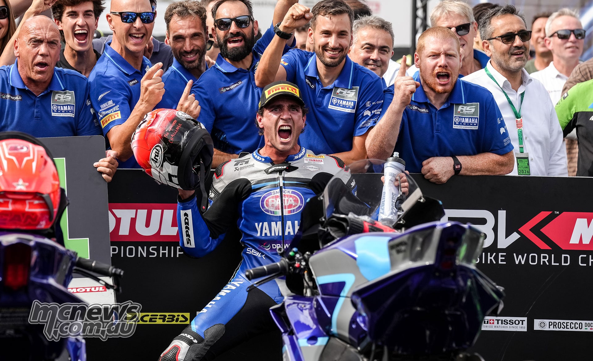 Albert Arenas celebrates his World Supersport Race One victory at Jerez in parc fermé surrounded by jubilant AS BLU CRU Racing Yamaha team members