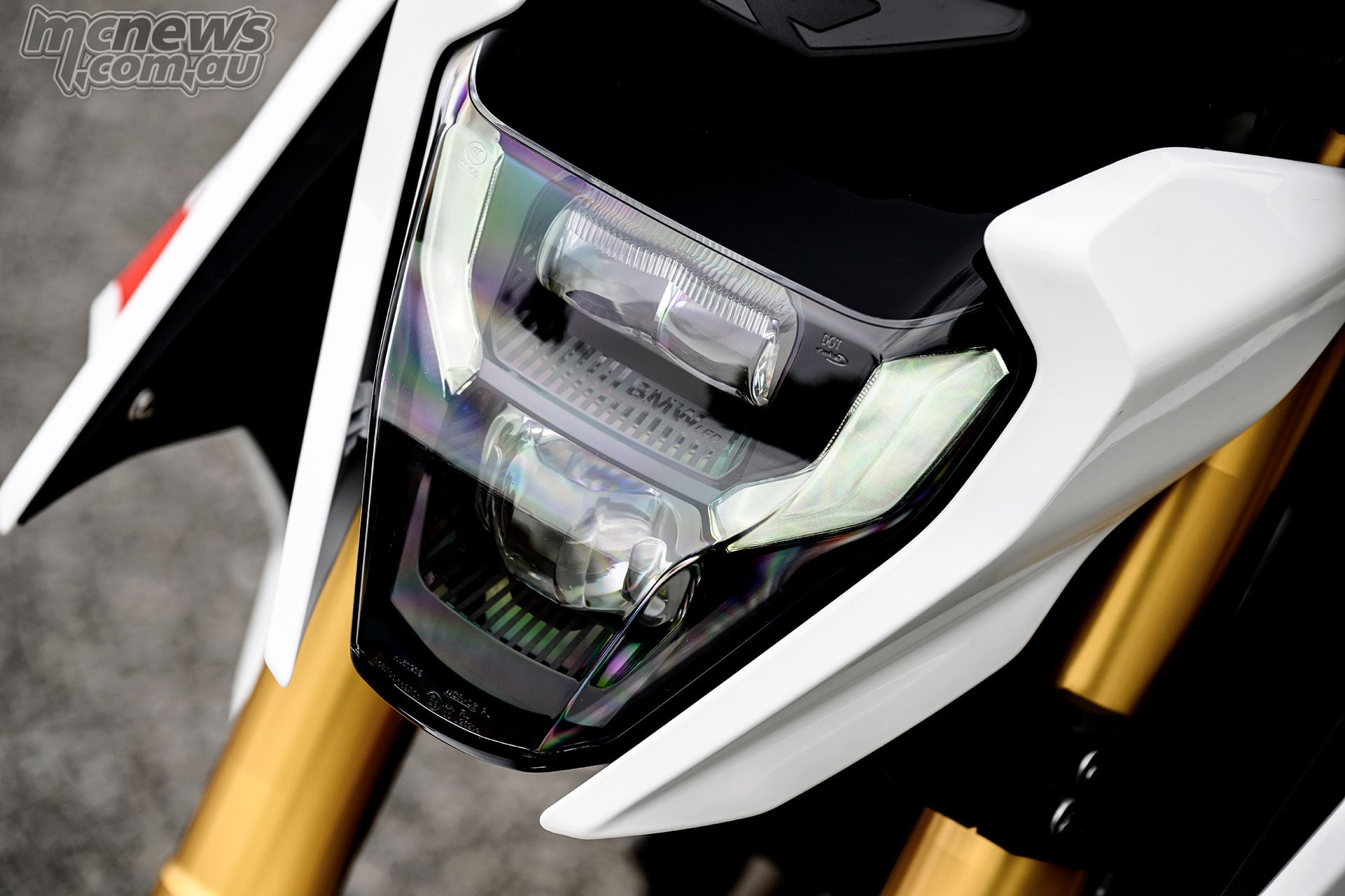 Close-up of the LED headlight and daytime running light on the white BMW F 450 R.