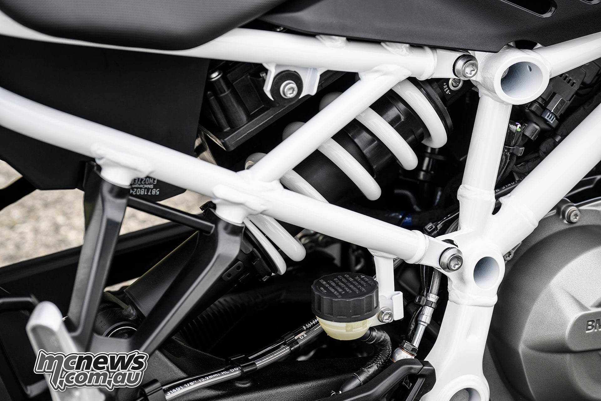 Close-up of the BMW F 450 R rear KYB shock, spring and tubular steel frame.
