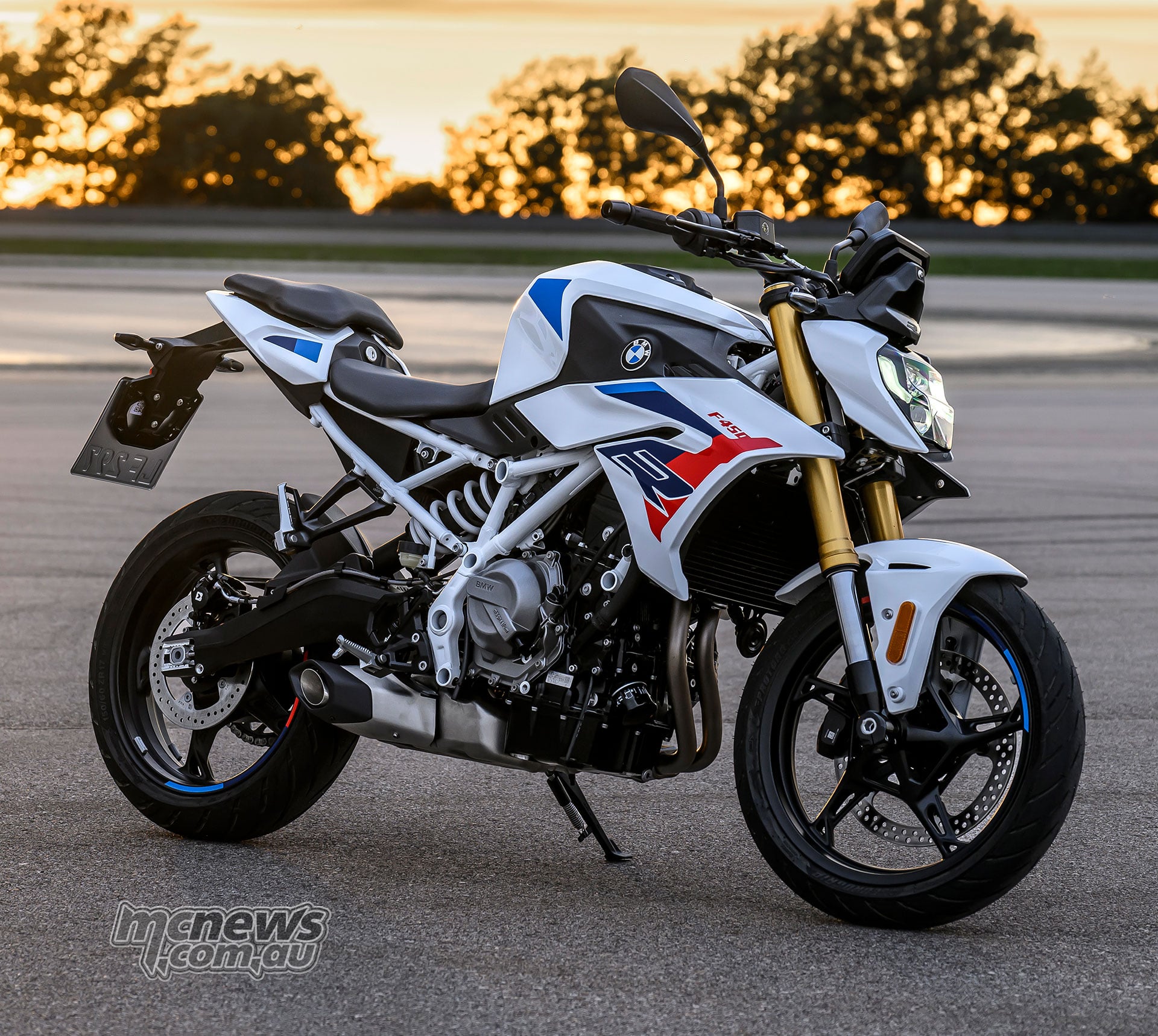 2027 BMW F 450 R M Sport parked at sunset, viewed from the front right side.