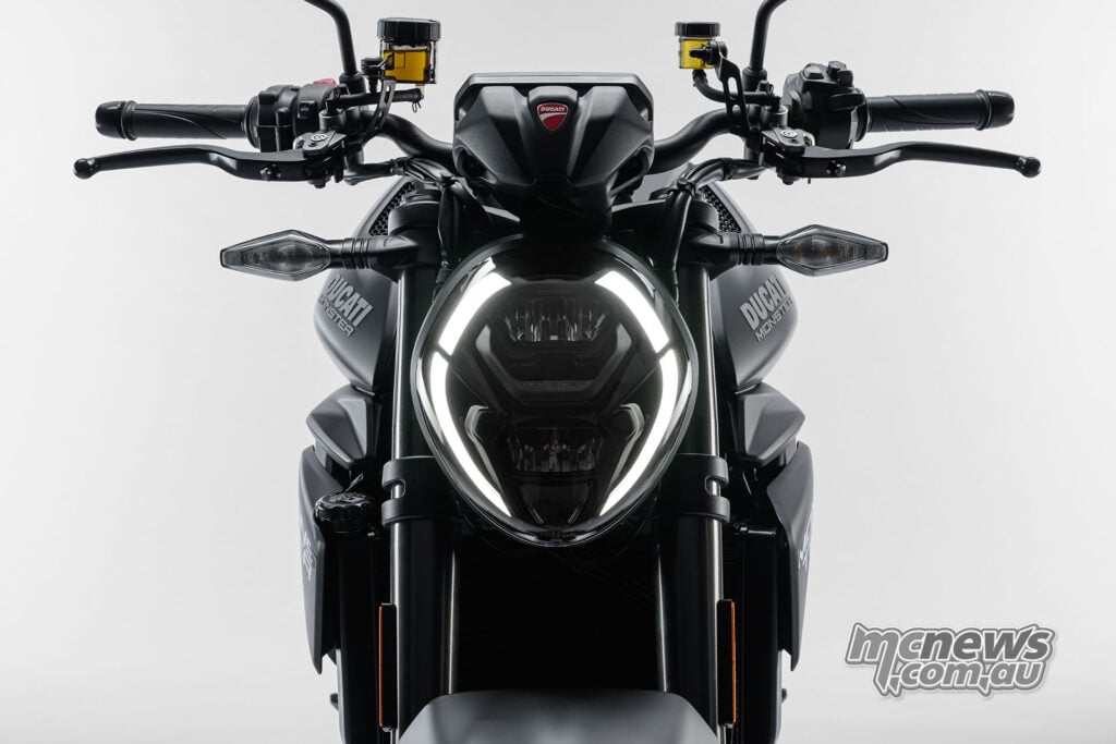 Front view of the Monster Dark LED headlight with illuminated daytime running lights, handlebars and mirrors