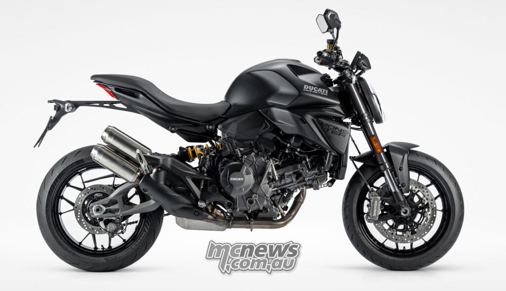 2027 Ducati Monster Dark in right-side profile, showing its black bodywork and twin exhaust silencers