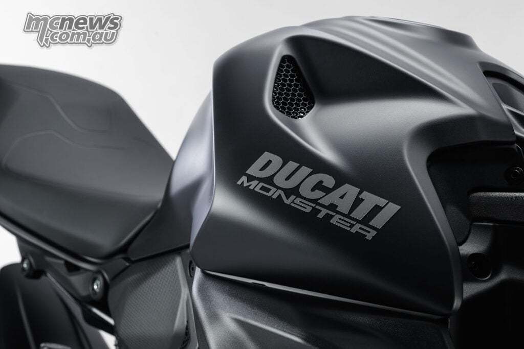 Close-up of the Monster Dark fuel tank with silver Ducati Monster lettering and black bodywork