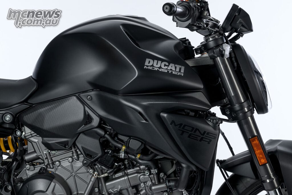 Right-side detail of the Ducati Monster Dark, showing the V2 engine beneath the tank and radiator shroud