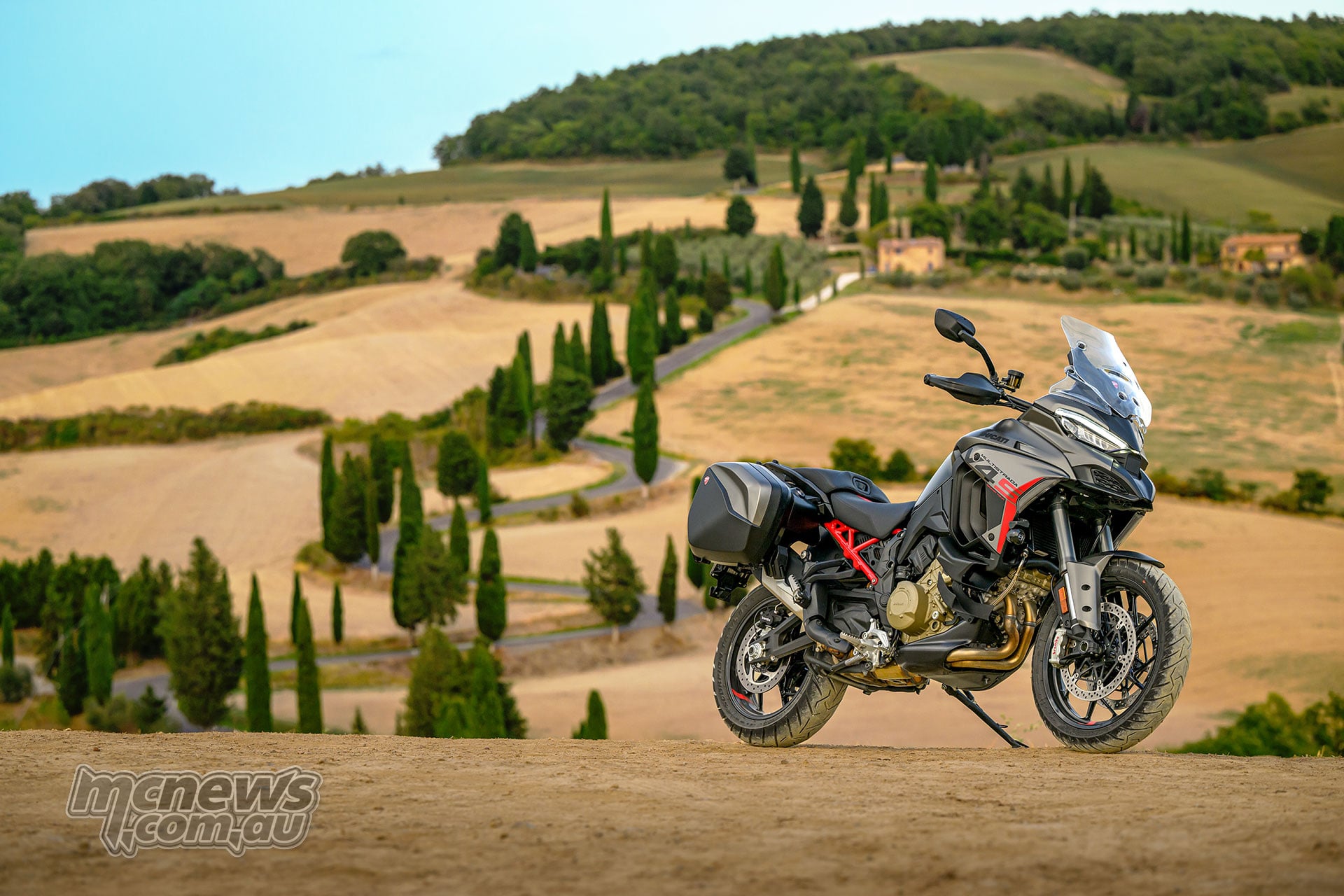 Front three-quarter view of the 2027 Ducati Multistrada V4 S Grand Tour parked beside the sea