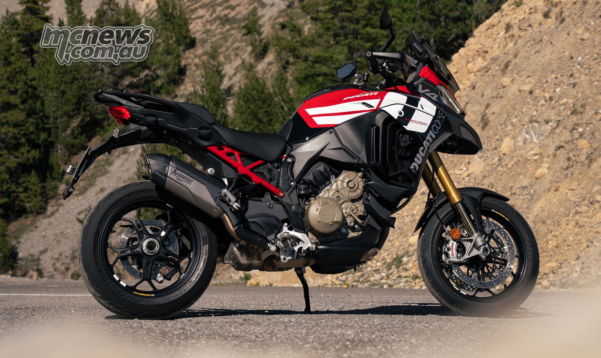 2027 Ducati Multistrada V4 Pikes Peak side profile with black forged 17 inch wheels and single sided swingarm