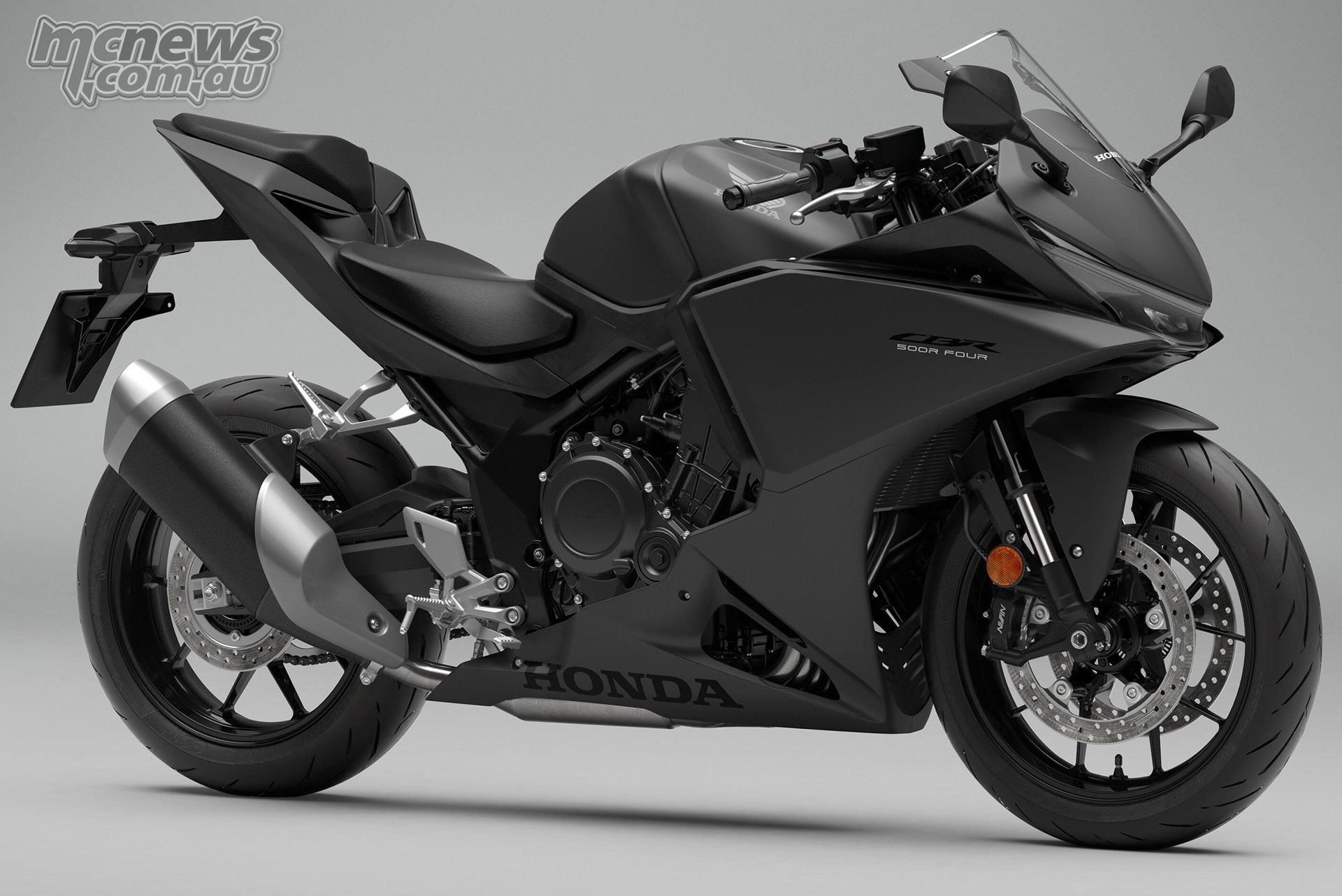 Front right three-quarter studio view of the 2027 Honda CBR500R FOUR in Mat Ballistic Black Metallic