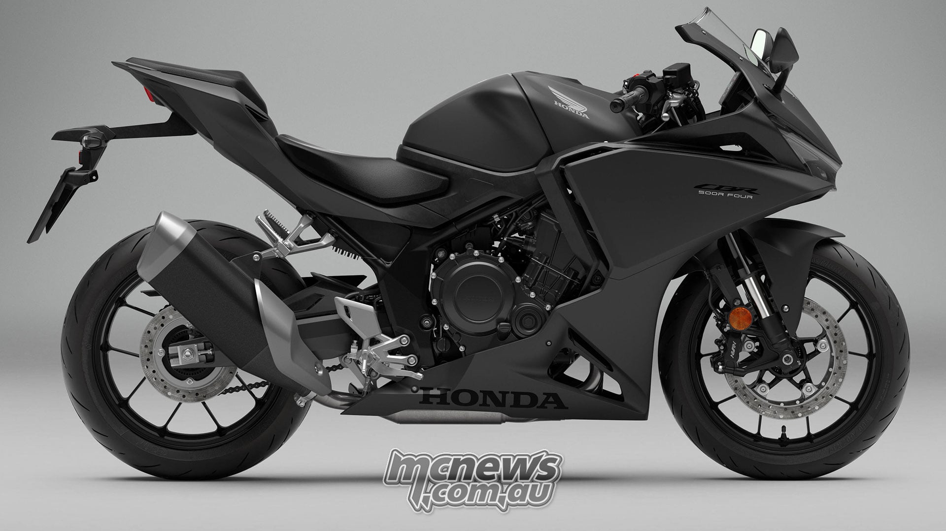 Right-side studio view of the black 2027 Honda CBR500R FOUR showing its fairing, fuel tank and exhaust