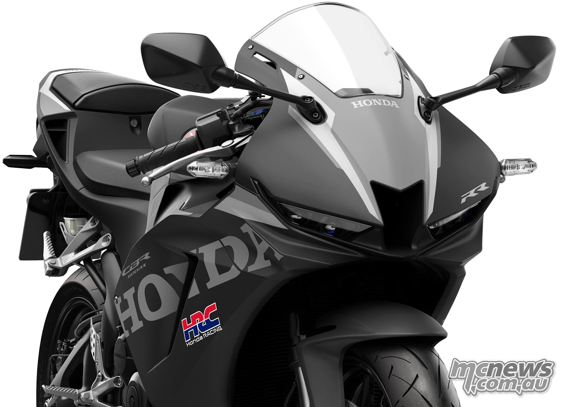 Front three-quarter studio detail of the black 2027 Honda CBR600RR showing its headlights, central air intake and revised front spoiler