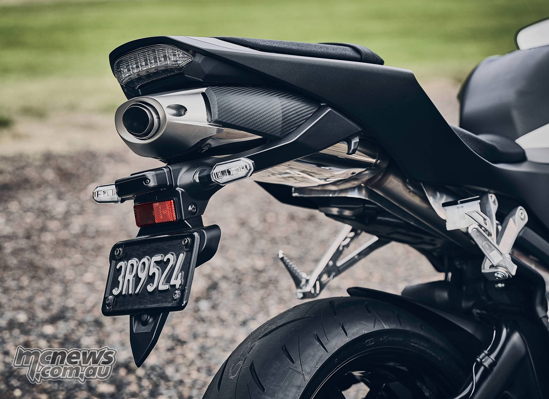 Rear detail of the black 2027 Honda CBR600RR showing its underseat exhaust, tail light, indicators and numberplate carrier