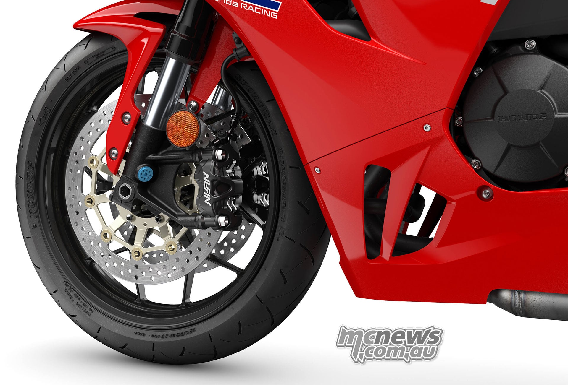 Close-up of the red 2027 Honda CBR600RR front wheel, floating brake disc and Nissin radial-mount caliper