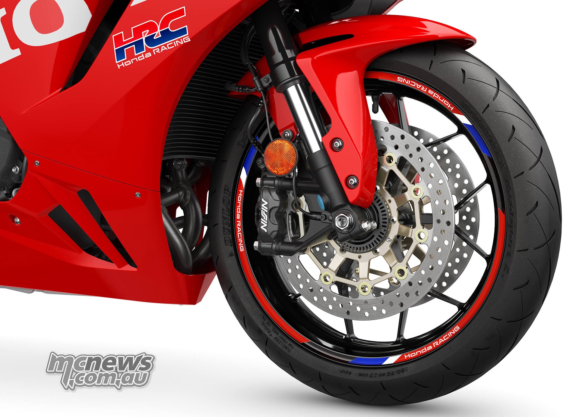 Front brake and Showa fork detail on the red 2027 Honda CBR600RR with HRC graphics and wheel stripes