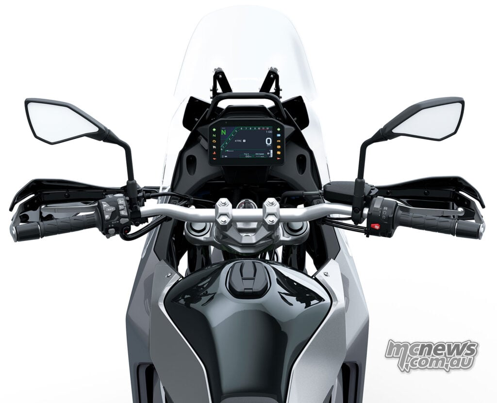 Rider's view of the Kawasaki KLE650 SE cockpit with TFT dashboard, handguards and tall windscreen.