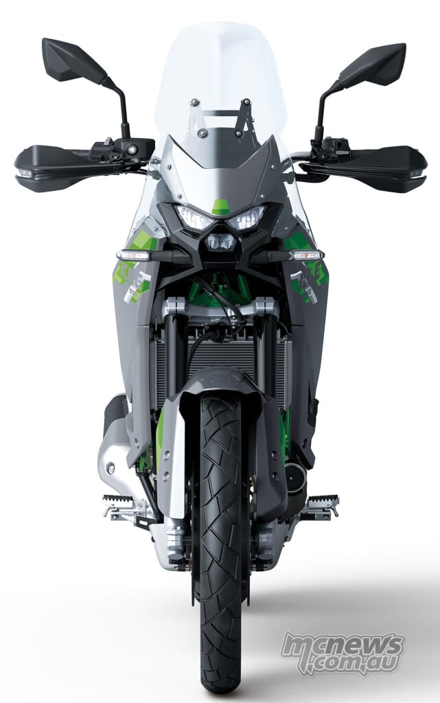 Head-on view of the Kawasaki KLE650 SE with its LED headlights illuminated.