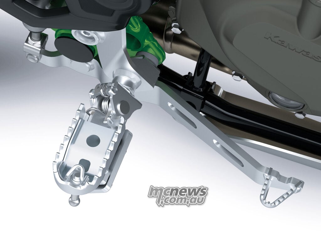 Close-up of the Kawasaki KLE650 SE rider footpeg, rear brake pedal and engine cover.