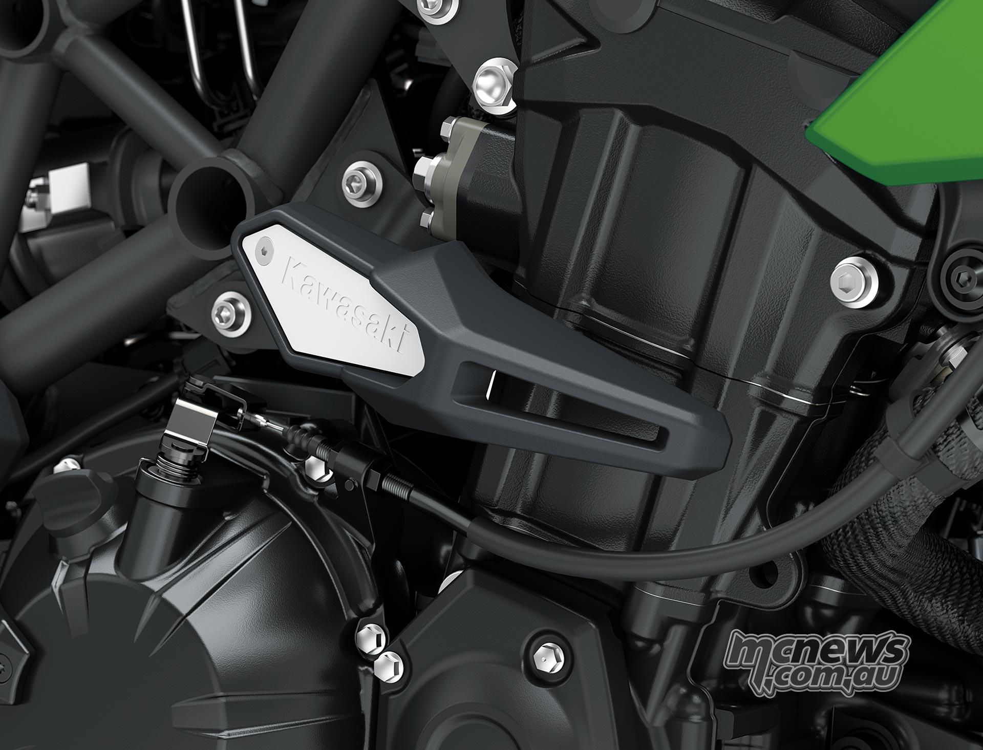 Black frame slider with a silver Kawasaki badge mounted beside the Versys 900 SE engine and trellis frame