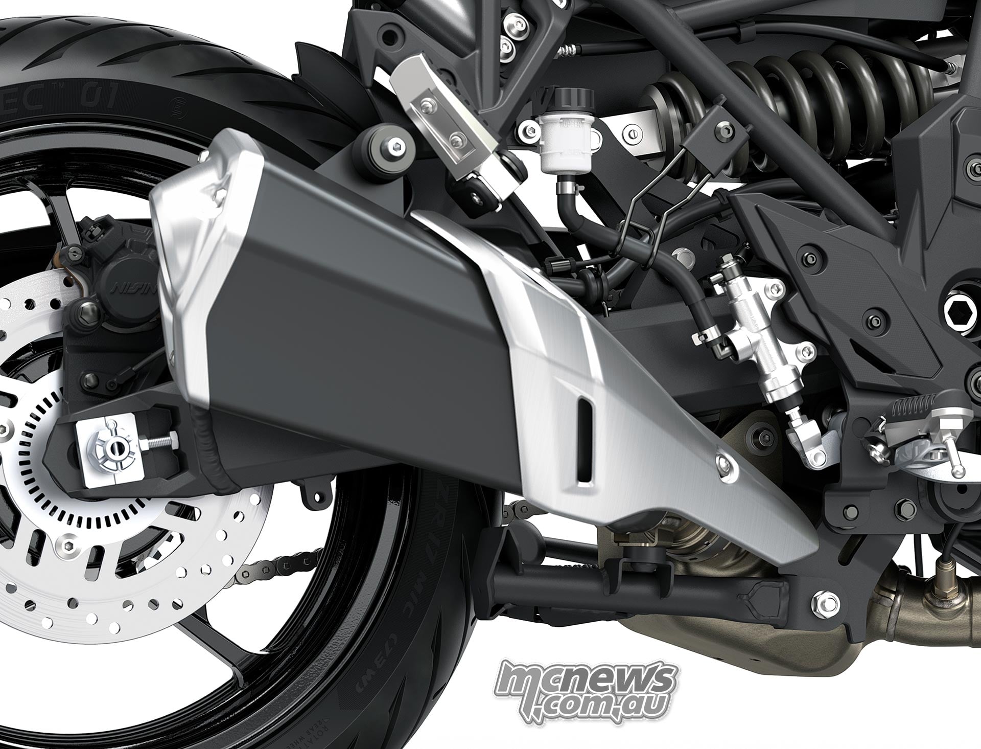 Black Kawasaki Versys 900 SE silencer with a metallic heat shield beside the rear wheel