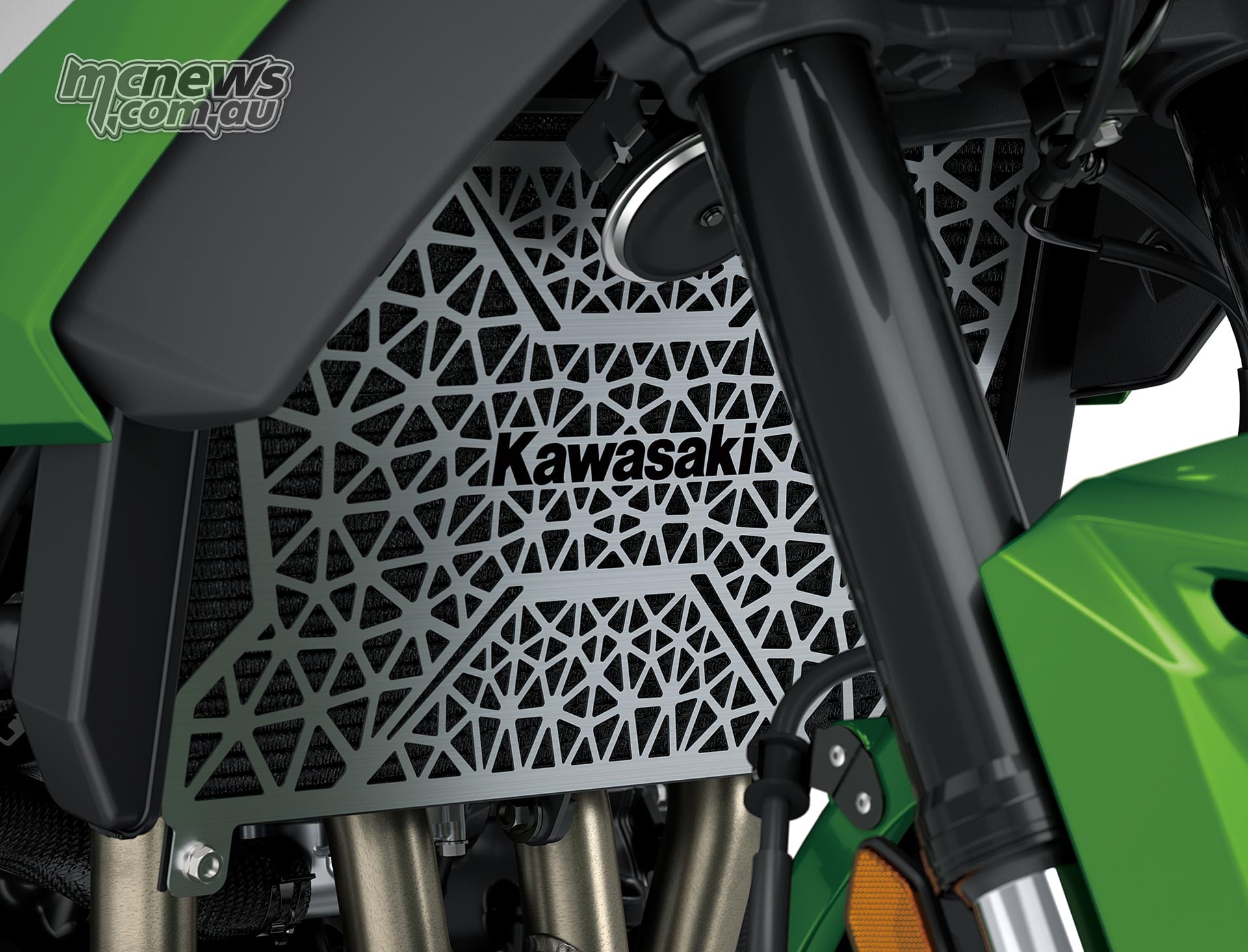 Perforated radiator screen with a Kawasaki logo behind the front fork of the Versys 900 SE